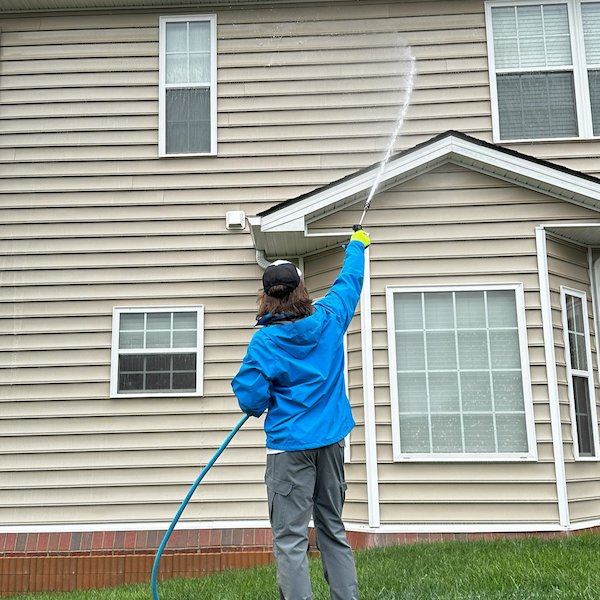 Close up of high-pressure water cleaning home siding in South Sioux City.
