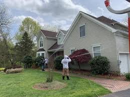 Professional technician washing the exterior walls of a home in Sergeant Bluff.