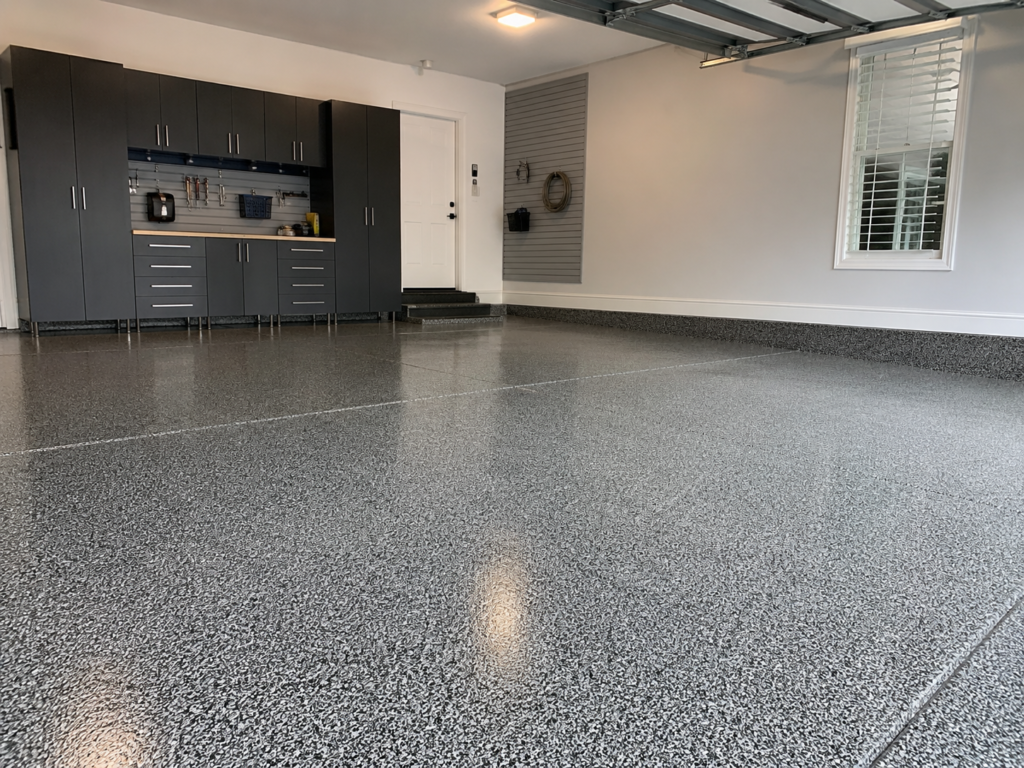 Epoxy garage floor with cabinets and wall storage